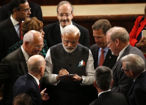 India Prime Minister Narendra Modi signs autographs after addressing a joint meeting of Congress in the House Chamber on Capitol Hill in Washington